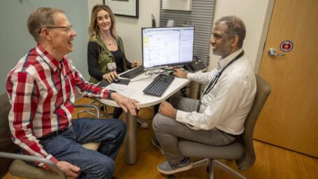 Sharmilan Thanendrarajan, M.D., Ph.D., and Anne Williams, APRN talk with patient John Lafave