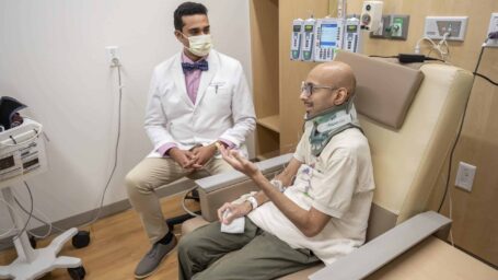 Anup Trikannad, M.D., and patient Harshad Inamdar talk over appointment results.
